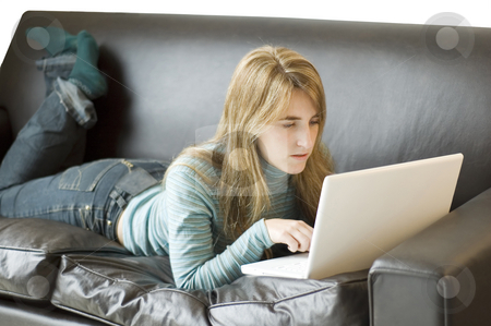 To use this stock image in your creative project, please select the size you need over to the right and click the "Add to Cart" button.
Your downloaded image will come with the Cutcaster watermark removed so don’t worry about the watermark you see on this page. Woman using laptop on sofa stock photo, A young woman relaxing at home on her sofa with her laptop by Lee Torrens