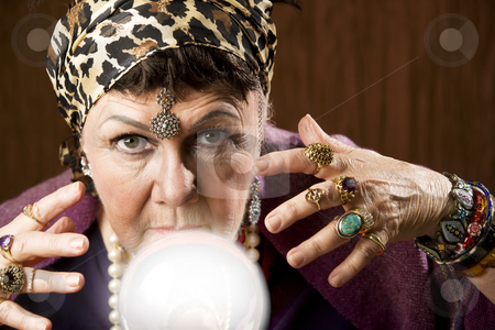 To use this stock image in your creative project, please select the size you need over to the right and click the "Add to Cart" button.
Your downloaded image will come with the Cutcaster watermark removed so don’t worry about the watermark you see on this page. Gyspy with a crystal ball stock photo, Female gypsy fortune teller with a crystal ball by Scott Griessel