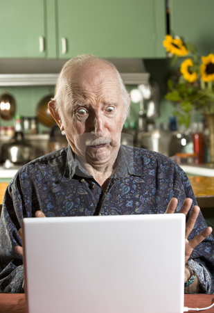 To use this stock image in your creative project, please select the size you need over to the right and click the "Add to Cart" button.
Your downloaded image will come with the Cutcaster watermark removed so don’t worry about the watermark you see on this page. Shocked Senior Man with a Laptop Computer stock photo, Shocked Senior Man in Dining Room with a Laptop Computer by Scott Griessel