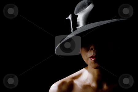 To use this stock image in your creative project, please select the size you need over to the right and click the "Add to Cart" button.
Your downloaded image will come with the Cutcaster watermark removed so don’t worry about the watermark you see on this page. Woman in shadow wearing a black hat stock photo, Mysterious woman in shadows wearing vintage black hat by Scott Griessel