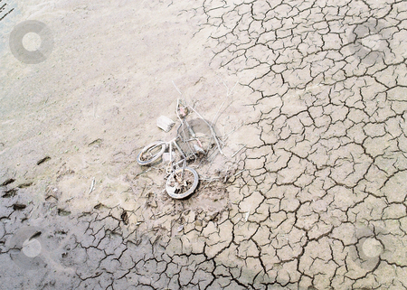 To use this stock image in your creative project, please select the size you need over to the right and click the "Add to Cart" button.
Your downloaded image will come with the Cutcaster watermark removed so don’t worry about the watermark you see on this page. Modern artifact_ bicycle on dry river bed stock photo, The draining of the Rock River left this bike embedded as a sureal fossil in the cracked clay. by Bruce Peterson