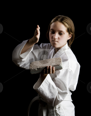 To use this stock image in your creative project, please select the size you need over to the right and click the "Add to Cart" button.
Your downloaded image will come with the Cutcaster watermark removed so don’t worry about the watermark you see on this page. Young girl karate chopping a brick stock photo, Young girl karate chopping a brick on black background by Scott Griessel