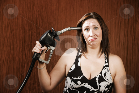 To use this stock image in your creative project, please select the size you need over to the right and click the "Add to Cart" button.
Your downloaded image will come with the Cutcaster watermark removed so don’t worry about the watermark you see on this page. Woman Holding Gas Nozzle to her Head stock photo, Woman holding gas nozzle like a gun to her head by Scott Griessel