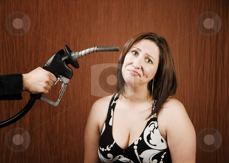 To use this stock image in your creative project, please select the size you need over to the right and click the "Add to Cart" button.
Your downloaded image will come with the Cutcaster watermark removed so don’t worry about the watermark you see on this page. Woman with Gas Nozzle to her Head stock photo, Woman with a gas nozzle pointed like a gun to her head by Scott Griessel