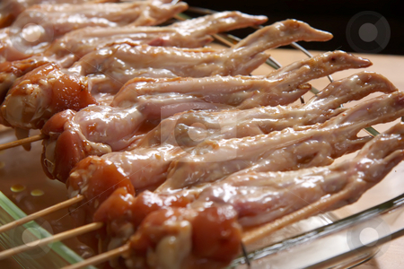To use this stock image in your creative project, please select the size you need over to the right and click the "Add to Cart" button.
Your downloaded image will come with the Cutcaster watermark removed so don’t worry about the watermark you see on this page. Raw chicken wings stock photo, Raw chicken wings marinating on wooden skewers by Kheng Guan Toh