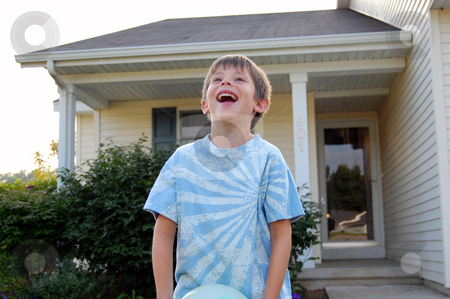 To use this stock image in your creative project, please select the size you need over to the right and click the "Add to Cart" button.
Your downloaded image will come with the Cutcaster watermark removed so don’t worry about the watermark you see on this page. Laughing boy playing in his front yard stock photo, Six year old boy laughing and playing in his front yard. by Heather Shelley