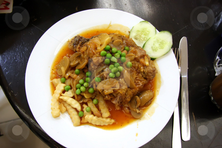 To use this stock image in your creative project, please select the size you need over to the right and click the "Add to Cart" button.
Your downloaded image will come with the Cutcaster watermark removed so don’t worry about the watermark you see on this page. Chicken chop stock photo, Fried chicken chop in gravy with fries and peas by Kheng Guan Toh