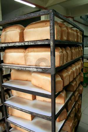 To use this stock image in your creative project, please select the size you need over to the right and click the "Add to Cart" button.
Your downloaded image will come with the Cutcaster watermark removed so don’t worry about the watermark you see on this page. Bakery bread stock photo, Rows of bread loaves in racks in a bakery by Kheng Guan Toh