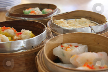 To use this stock image in your creative project, please select the size you need over to the right and click the "Add to Cart" button.
Your downloaded image will come with the Cutcaster watermark removed so don’t worry about the watermark you see on this page. Steamed dimsum stock photo, Chinese steamed dimsum in bamboo containers traditional cuisine by Kheng Guan Toh