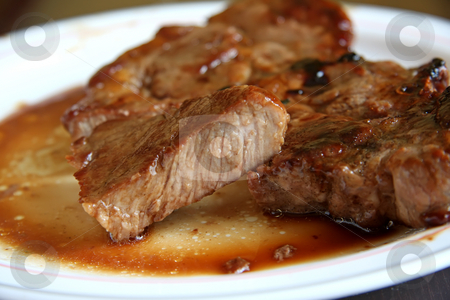 To use this stock image in your creative project, please select the size you need over to the right and click the "Add to Cart" button.
Your downloaded image will come with the Cutcaster watermark removed so don’t worry about the watermark you see on this page. Pork chop stock photo, Cooked pork chop on a plate cut medium well done by Kheng Guan Toh