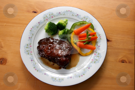 To use this stock image in your creative project, please select the size you need over to the right and click the "Add to Cart" button.
Your downloaded image will come with the Cutcaster watermark removed so don’t worry about the watermark you see on this page. Porkchop with vegetables stock photo, Porkchops with gravy and vegetables on plate by Kheng Guan Toh