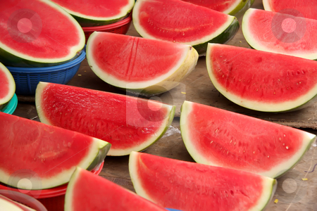 To use this stock image in your creative project, please select the size you need over to the right and click the "Add to Cart" button.
Your downloaded image will come with the Cutcaster watermark removed so don’t worry about the watermark you see on this page. Sliced watermelon stock photo, Rows of sliced quartered watermelon for sale in market by Kheng Guan Toh