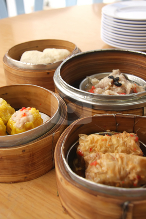 To use this stock image in your creative project, please select the size you need over to the right and click the "Add to Cart" button.
Your downloaded image will come with the Cutcaster watermark removed so don’t worry about the watermark you see on this page. Steamed dimsum stock photo, Chinese steamed dimsum in bamboo containers traditional cuisine by Kheng Guan Toh