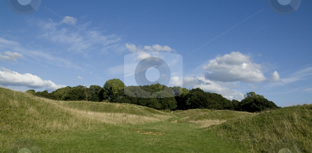 To use this stock image in your creative project, please select the size you need over to the right and click the "Add to Cart" button.
Your downloaded image will come with the Cutcaster watermark removed so don’t worry about the watermark you see on this page. Entrance to Badbury Rings Hillfort stock photo, This site has been occupied for at least 4,000 years. It is one of the possible sites for the battle of Baden when the legendary King Arthur defeated the Saxons and temporarily stemmed their invasion. The Romans over ran the site and then occupied the surrounding land. It last saw action when the