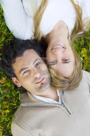 To use this stock image in your creative project, please select the size you need over to the right and click the "Add to Cart" button.
Your downloaded image will come with the Cutcaster watermark removed so don’t worry about the watermark you see on this page. Young Couple Relaxing on a Lawn stock photo, A young couple lying down and relaxing on a grass lawn by Lee Torrens