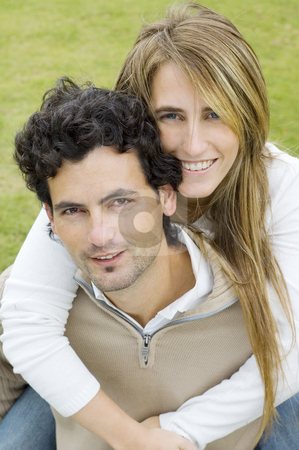 To use this stock image in your creative project, please select the size you need over to the right and click the "Add to Cart" button.
Your downloaded image will come with the Cutcaster watermark removed so don’t worry about the watermark you see on this page. Young couple stock photo, A young couple playing affectionately in a garden, both looking at the camera by Lee Torrens
