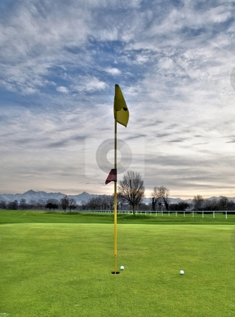 To use this stock image in your creative project, please select the size you need over to the right and click the "Add to Cart" button.
Your downloaded image will come with the Cutcaster watermark removed so don’t worry about the watermark you see on this page. Golf course stock photo, Scenic view of a golf course with mountains in the background by Laurent Dambies