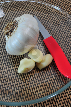 To use this stock image in your creative project, please select the size you need over to the right and click the "Add to Cart" button.
Your downloaded image will come with the Cutcaster watermark removed so don’t worry about the watermark you see on this page. Garlic Cloves And Knife stock photo, Whole garlic and pealed cloves on clear glass plate with a red handled knife. by Lynn Bendickson