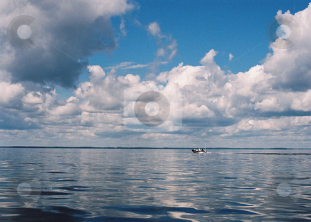 To use this stock image in your creative project, please select the size you need over to the right and click the "Add to Cart" button.
Your downloaded image will come with the Cutcaster watermark removed so don’t worry about the watermark you see on this page. Surreal scene_boat on water stock photo, Still waters and cloud cover foretell impending events on Lake Winnibigoshish, Minnesota. by Bruce Peterson