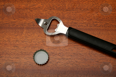 To use this stock image in your creative project, please select the size you need over to the right and click the "Add to Cart" button.
Your downloaded image will come with the Cutcaster watermark removed so don’t worry about the watermark you see on this page. Opener and cap stock photo, Bottle/can opener with black handle on wooden surface next to generic bottle cap. by Clay Anthony