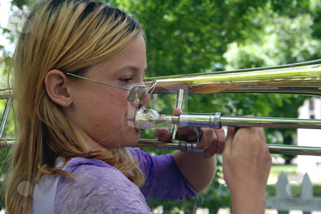 To use this stock image in your creative project, please select the size you need over to the right and click the "Add to Cart" button.
Your downloaded image will come with the Cutcaster watermark removed so don’t worry about the watermark you see on this page. Natural trombonist stock photo, Pre-teen girl playing a trombone outside. by Clay Anthony
