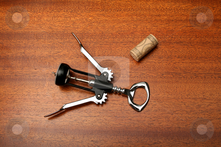 To use this stock image in your creative project, please select the size you need over to the right and click the "Add to Cart" button.
Your downloaded image will come with the Cutcaster watermark removed so don’t worry about the watermark you see on this page. Corkscrew stock photo, A wine opener and cork sitting on wooden bar surface. by Clay Anthony