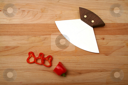 To use this stock image in your creative project, please select the size you need over to the right and click the "Add to Cart" button.
Your downloaded image will come with the Cutcaster watermark removed so don’t worry about the watermark you see on this page. Ulu stock photo, An ulu (Eskimo) knife sitting on a cutting board next to chopped red pepper. by Clay Anthony