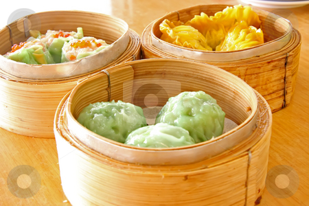 To use this stock image in your creative project, please select the size you need over to the right and click the "Add to Cart" button.
Your downloaded image will come with the Cutcaster watermark removed so don’t worry about the watermark you see on this page. Steamed dimsum stock photo, Chinese steamed dimsum in bamboo containers traditional cuisine by Kheng Guan Toh