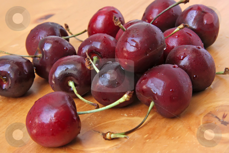 To use this stock image in your creative project, please select the size you need over to the right and click the "Add to Cart" button.
Your downloaded image will come with the Cutcaster watermark removed so don’t worry about the watermark you see on this page. Fresh cherries stock photo, Fresh whole cherries with stalk on wooden background by Kheng Guan Toh