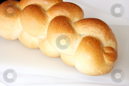To use this stock image in your creative project, please select the size you need over to the right and click the "Add to Cart" button.
Your downloaded image will come with the Cutcaster watermark removed so don’t worry about the watermark you see on this page. Country bread stock photo, Loaf of fresh whole braided country bread by Kheng Guan Toh