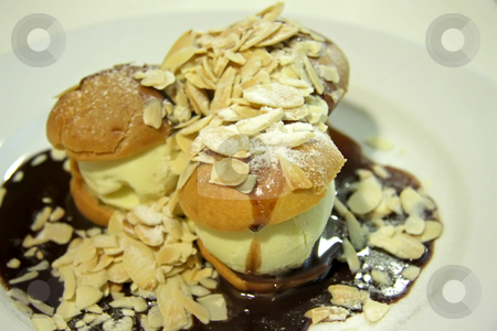 To use this stock image in your creative project, please select the size you need over to the right and click the "Add to Cart" button.
Your downloaded image will come with the Cutcaster watermark removed so don’t worry about the watermark you see on this page. Profiteroles stock photo, Profiteroles with ice cream and chocolate suace with nuts by Kheng Guan Toh