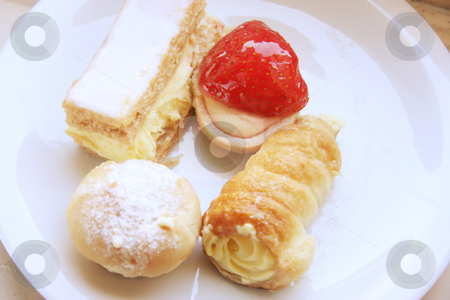 To use this stock image in your creative project, please select the size you need over to the right and click the "Add to Cart" button.
Your downloaded image will come with the Cutcaster watermark removed so don’t worry about the watermark you see on this page. Assorted fancy pastries stock photo, Assorted fancy cream pastry desserts on white plate by Kheng Guan Toh
