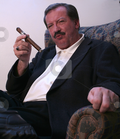 To use this stock image in your creative project, please select the size you need over to the right and click the "Add to Cart" button.
Your downloaded image will come with the Cutcaster watermark removed so don’t worry about the watermark you see on this page. Walsh Attitude stock photo, Mike Walsh enjoys a cigar while relaxing in his Casper, WY apartment. by Clay Anthony