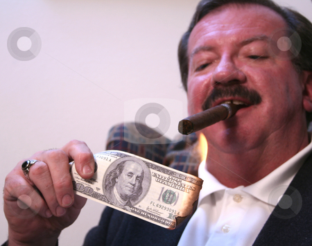 To use this stock image in your creative project, please select the size you need over to the right and click the "Add to Cart" button.
Your downloaded image will come with the Cutcaster watermark removed so don’t worry about the watermark you see on this page. Money to Burn stock photo, Mike Walsh lights a cigar with a $100 bill in his Casper, WY apartment. by Clay Anthony
