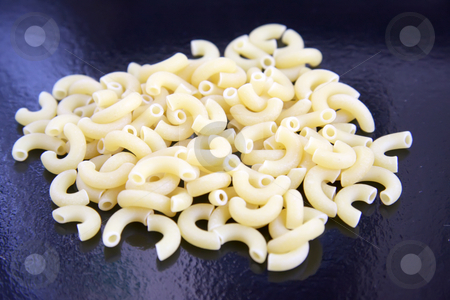 To use this stock image in your creative project, please select the size you need over to the right and click the "Add to Cart" button.
Your downloaded image will come with the Cutcaster watermark removed so don’t worry about the watermark you see on this page. Raw macaroni stock photo, Raw macaroni pasta shells in a pile by Kheng Guan Toh