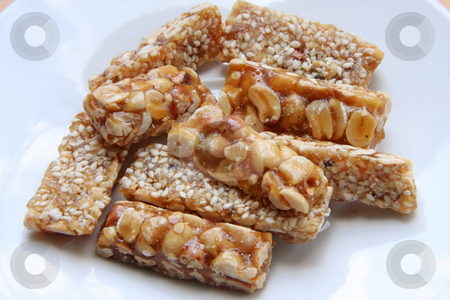 To use this stock image in your creative project, please select the size you need over to the right and click the "Add to Cart" button.
Your downloaded image will come with the Cutcaster watermark removed so don’t worry about the watermark you see on this page. Peanut brittle stock photo, Peanut brittle sweet hard nut snack crunchy pieces by Kheng Guan Toh
