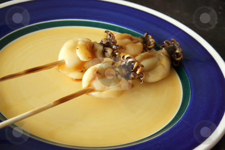 To use this stock image in your creative project, please select the size you need over to the right and click the "Add to Cart" button.
Your downloaded image will come with the Cutcaster watermark removed so don’t worry about the watermark you see on this page. Squid skewers stock photo, Skewered squid on wooden sticks grilled tentacles by Kheng Guan Toh