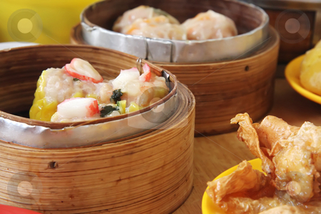 To use this stock image in your creative project, please select the size you need over to the right and click the "Add to Cart" button.
Your downloaded image will come with the Cutcaster watermark removed so don’t worry about the watermark you see on this page. Chinese dimsum stock photo, Chinese steamed dimsum in bamboo containers traditional cuisine by Kheng Guan Toh