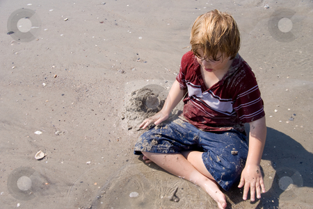 To use this stock image in your creative project, please select the size you need over to the right and click the "Add to Cart" button.
Your downloaded image will come with the Cutcaster watermark removed so don’t worry about the watermark you see on this page. Boy Playing at the Ocean stock photo, A young boy playing at the ocean. by Robert Byron