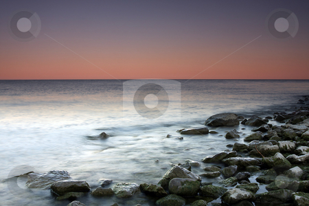 To use this stock image in your creative project, please select the size you need over to the right and click the "Add to Cart" button.
Your downloaded image will come with the Cutcaster watermark removed so don’t worry about the watermark you see on this page. Sunset Hues stock photo, Beautiful Sunset over Lake Ontario using slow shutter speed. by Megan Lorenz