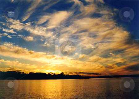 To use this stock image in your creative project, please select the size you need over to the right and click the "Add to Cart" button.
Your downloaded image will come with the Cutcaster watermark removed so don’t worry about the watermark you see on this page. Sunset over calm lake stock photo, A serene theme seems naturally painted for this sunset scene on Cutfoot Sioux Lake in Minnesota by Bruce Peterson