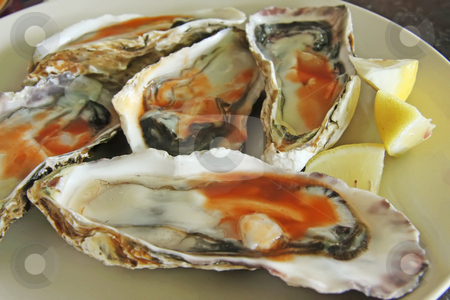 To use this stock image in your creative project, please select the size you need over to the right and click the "Add to Cart" button.
Your downloaded image will come with the Cutcaster watermark removed so don’t worry about the watermark you see on this page. Fresh raw oysters stock photo, Raw fresh oysters in half shell with spicy sauce by Kheng Guan Toh