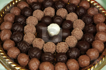 To use this stock image in your creative project, please select the size you need over to the right and click the "Add to Cart" button.
Your downloaded image will come with the Cutcaster watermark removed so don’t worry about the watermark you see on this page. Chocolate truffles stock photo, Fancy chocolate truffle balls arranged in circles by Kheng Guan Toh