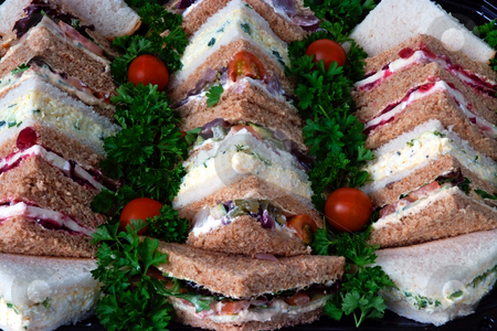 To use this stock image in your creative project, please select the size you need over to the right and click the "Add to Cart" button.
Your downloaded image will come with the Cutcaster watermark removed so don’t worry about the watermark you see on this page. Quick lunch stock photo, Sandwiches cut into triangles on a tray prepared for a business lunch by Paul Phillips
