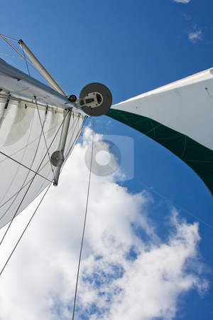 To use this stock image in your creative project, please select the size you need over to the right and click the "Add to Cart" button.
Your downloaded image will come with the Cutcaster watermark removed so don’t worry about the watermark you see on this page. Sails stock photo, Sails, GPS and radar of a catamaran boat with a deep blue sky and white cloud by Paul Hakimata