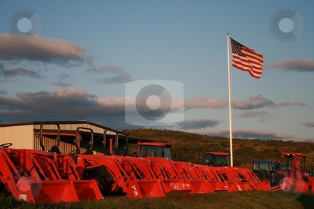 To use this stock image in your creative project, please select the size you need over to the right and click the "Add to Cart" button.
Your downloaded image will come with the Cutcaster watermark removed so don’t worry about the watermark you see on this page. Kubotas under the US Flag stock photo, Kubota equipment under a blue sky and the US flag by Tom and Beth Pulsipher