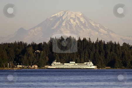 To use this stock image in your creative project, please select the size you need over to the right and click the "Add to Cart" button.
Your downloaded image will come with the Cutcaster watermark removed so don’t worry about the watermark you see on this page. Mt. Rainier stock photo, July 17, 2003 : A Washington State Ferry could be seen passing through Sinclair Inlet with a snow topped Mt. Rainier behind it. The view from Illahee fishing pier on a sunny day can offer some breath taking pictures in Bremerton, Washington by Jesse Beals