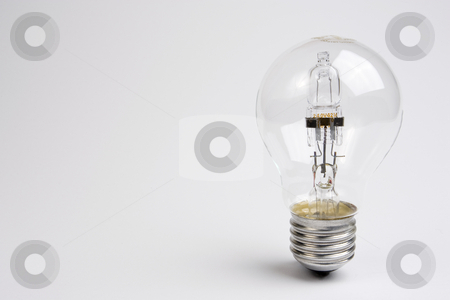 To use this stock image in your creative project, please select the size you need over to the right and click the "Add to Cart" button.
Your downloaded image will come with the Cutcaster watermark removed so don’t worry about the watermark you see on this page. Halogen Lightbulb stock photo, A halogen lightbulb standing on the right-hand side of a white frame. by Steve Smith