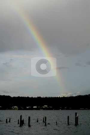 To use this stock image in your creative project, please select the size you need over to the right and click the "Add to Cart" button.
Your downloaded image will come with the Cutcaster watermark removed so don’t worry about the watermark you see on this page. Rainbow stock photo, October 9, 2003 : A rainbow could be seen peaking through the rain storm clouds over head in Dyes Inlet in Silverdale, Washington. by Jesse Beals