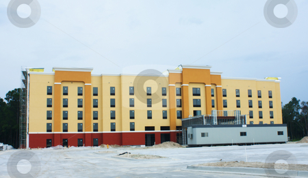 To use this stock image in your creative project, please select the size you need over to the right and click the "Add to Cart" button.
Your downloaded image will come with the Cutcaster watermark removed so don’t worry about the watermark you see on this page. Hotel construction stock photo, Construction site of modern motel near an interstate highway by Lee Barnwell
